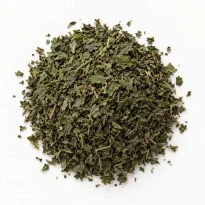 Loose dried nettle leaf on a warm-white background.